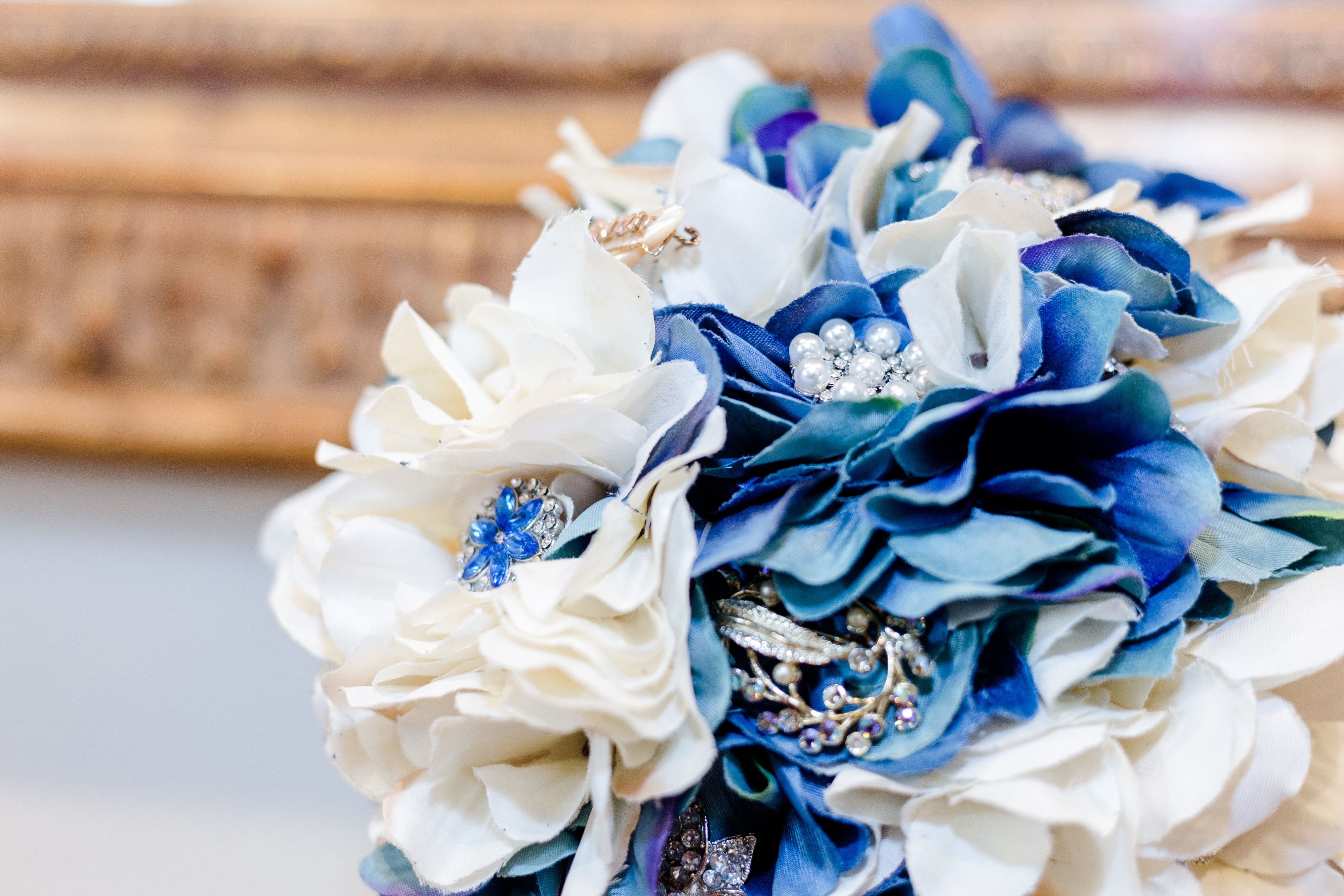 Closeup of a blue wedding bouquet with jewels and embellishments