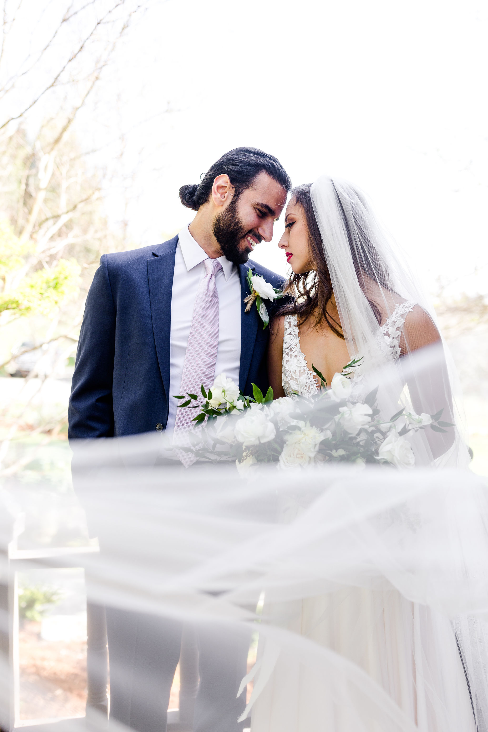 Bride and groom with long flowing veil