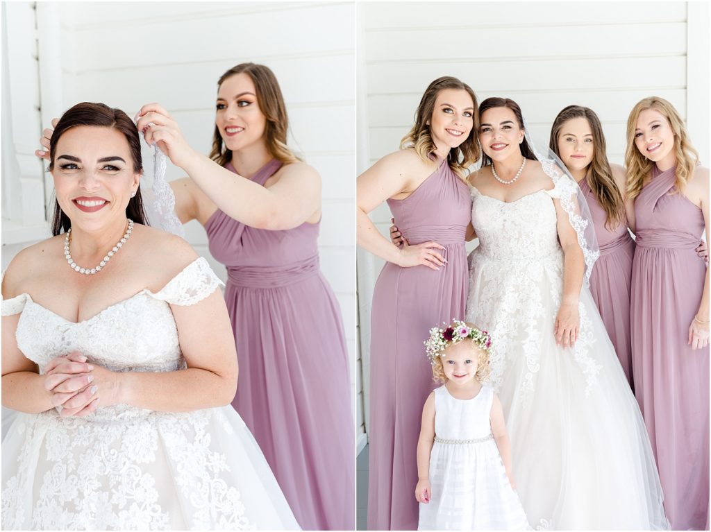 Bride gets her veil put on and stands with her bridesmaids and flower girl.