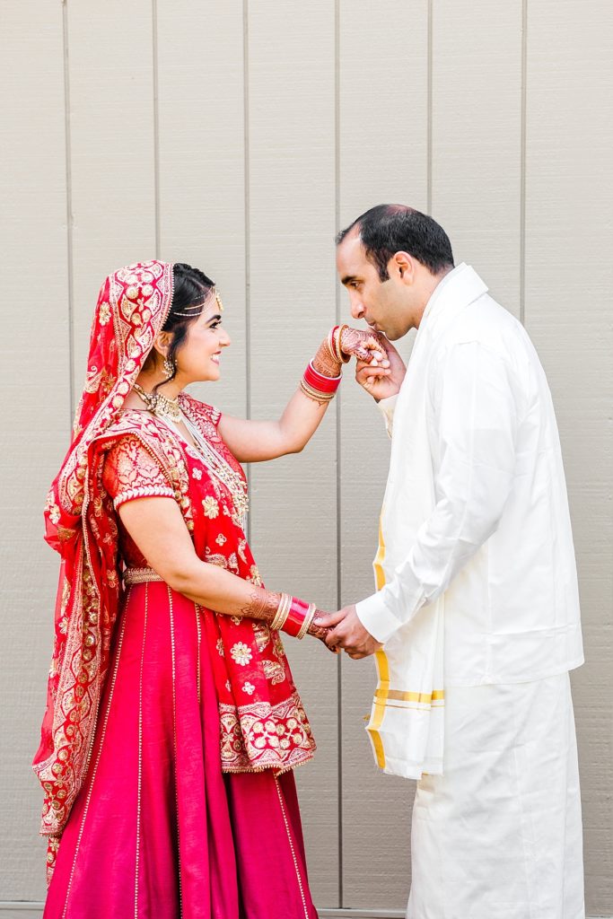 Indian bride and groom's first look at Napa Silverado Resort, groom kisses bride's hand, shot by Amber Rivas Photography