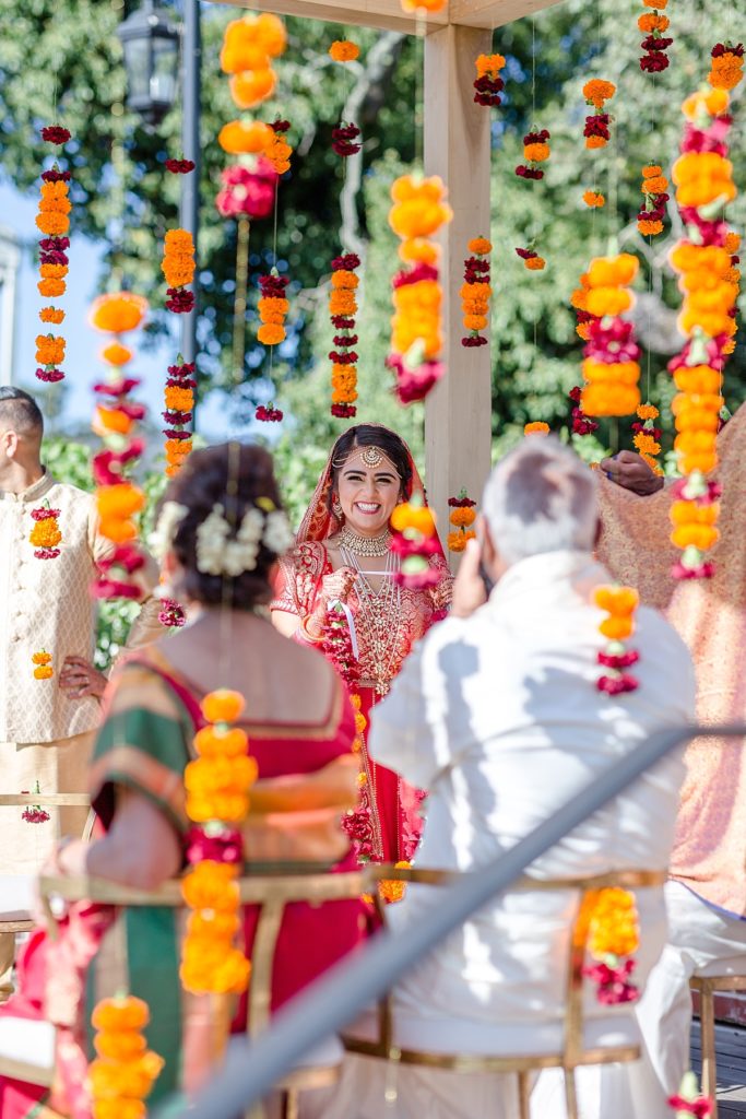 Bride and groom exchange flower garlands at Napa Silverado Resort, shot by Amber Rivas Photography