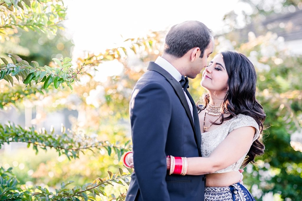 Bride and groom touch noses during golden hour at Indian wedding reception at Napa Silverado Resort, shot by Amber Rivas Photography