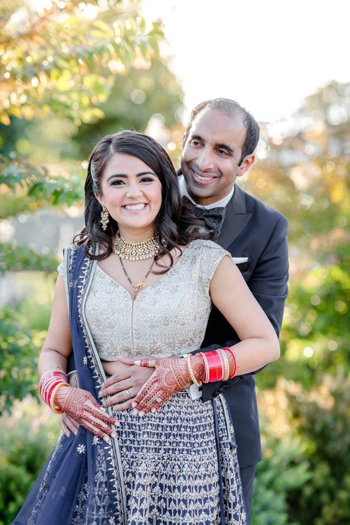 Bride and groom smile at the camera at Indian wedding reception at Napa Silverado Resort, shot by Amber Rivas Photography