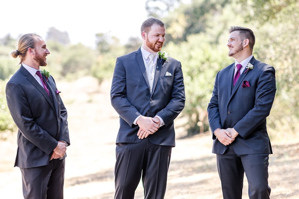 Groom with best man and groomsman. Standing around talking at The Orchard in Watsonville, CA.