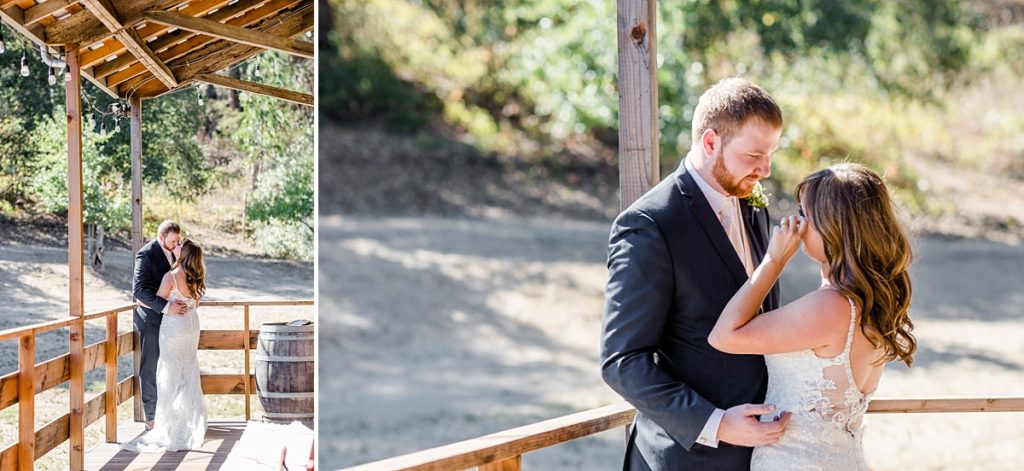 Bride and groom kiss during their first look at the barn at The Orchard in Watsonville, CA. Bride cries when groom sees her for the first time.