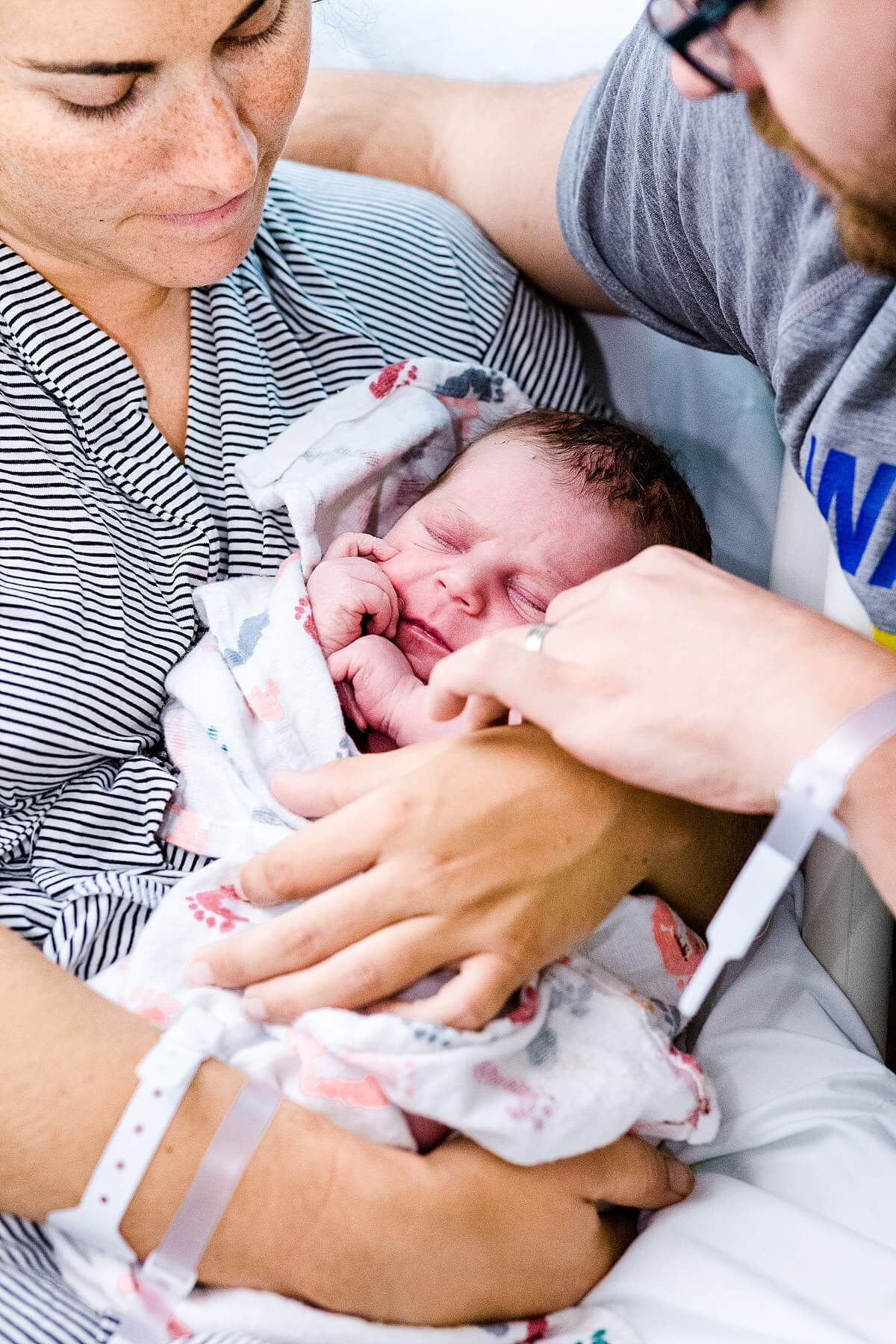 New mom and dad holding baby in the hospital