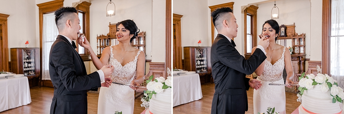 Bride and groom share bites of wedding cake at the Ravenswood Historic Site house.