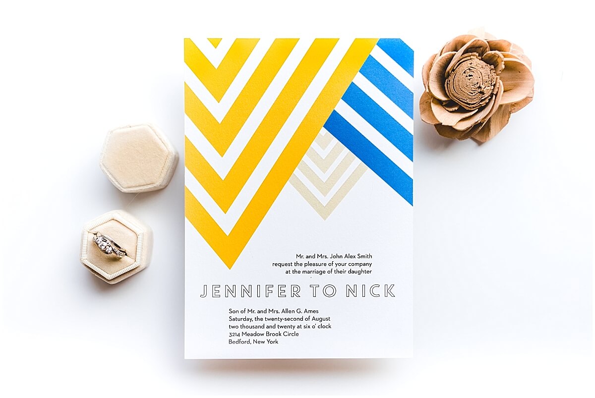Modern blue and yellow wedding invitation with geometric patterns