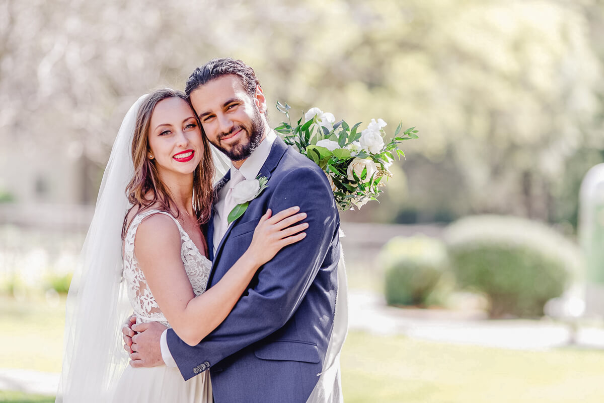 Bride and groom portrait with white floral bouquet