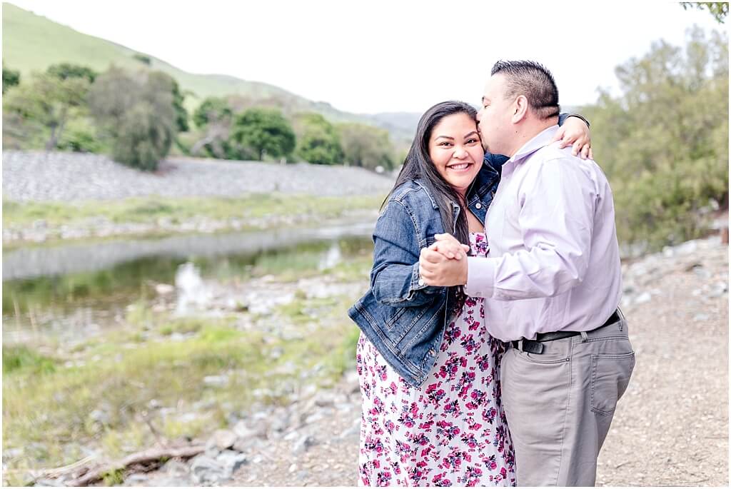 Couple on a trail at Niles Canyon near the staging area, hugging in front of the water
