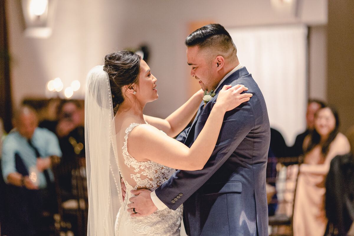 Bride and groom share a first dance during their Palm Event Center winter wedding